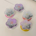 Magnetic translucent purple and pink resin flower MagSafe phone grip with floating holographic star glitter and collapsible stand.