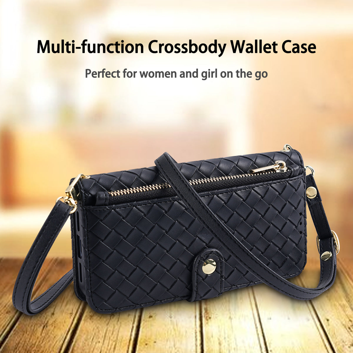 Black woven leather crossbody wallet case with gold zipper pouch and adjustable shoulder strap resting on wooden table.