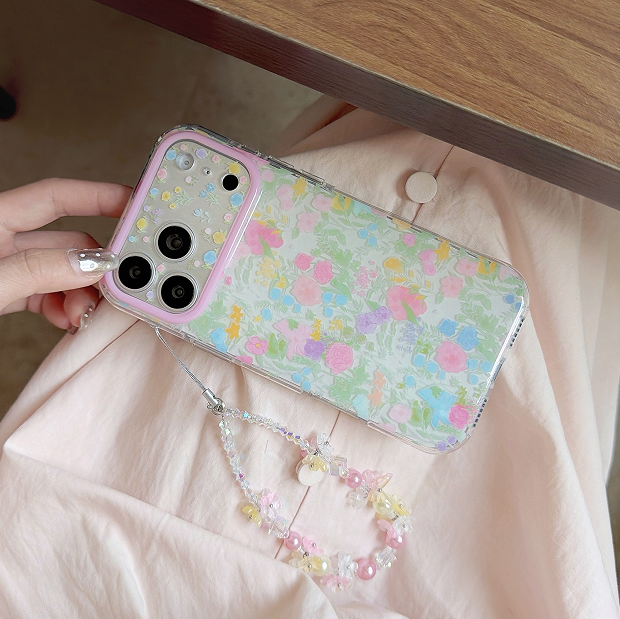 Cherry blossom floral phone case with beaded strap on iPhone showing soft pink flowers, cream pearls, and multi-color beads