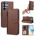 Classic brown leather wallet case for Samsung Galaxy Ultra shown from 5 angles including camera lens cutout, wristlet strap carry, horizontal kickstand mode, and interior wallet layout with card slots and photo window.