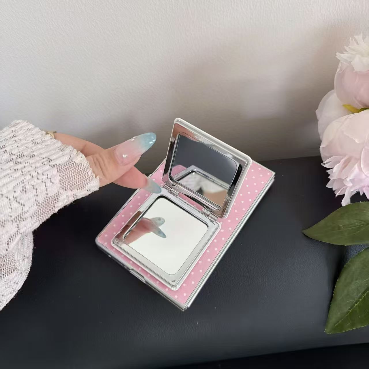 Close-up detail of the pink polka dot Samsung Galaxy Z Fold 8 case showing double HD vanity mirrors inside the open flap.