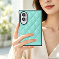 Close-up view of woman holding a mint green quilted diamond leather case on a Galaxy Z Fold 8