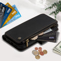 Close-up of black leather zipper wallet case holding credit cards, coins, and folded cash bill