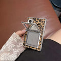 Close-up of open double vanity mirror compact on leopard print Samsung Galaxy Z Fold cover