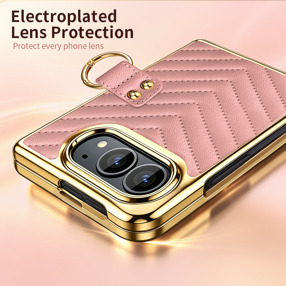 Close-up view of pink chevron quilted leather case for iPhone DUO highlighting raised electroplated gold camera lens bezel and gold finger ring clasp.