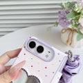 Close-up view of the lavender polka dot iPhone DUO case showing the elevated camera protection ring bezel and crystal rhinestone heart mirror detail.