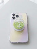 Close up view of clear faceted coconut cocktail phone grip showing shaker charms and magnetic base