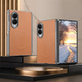 Cognac brown leather folding phone case with clear bumper frame and magnetic ring back, shown closed and open displaying winter landscape screen wallpaper.