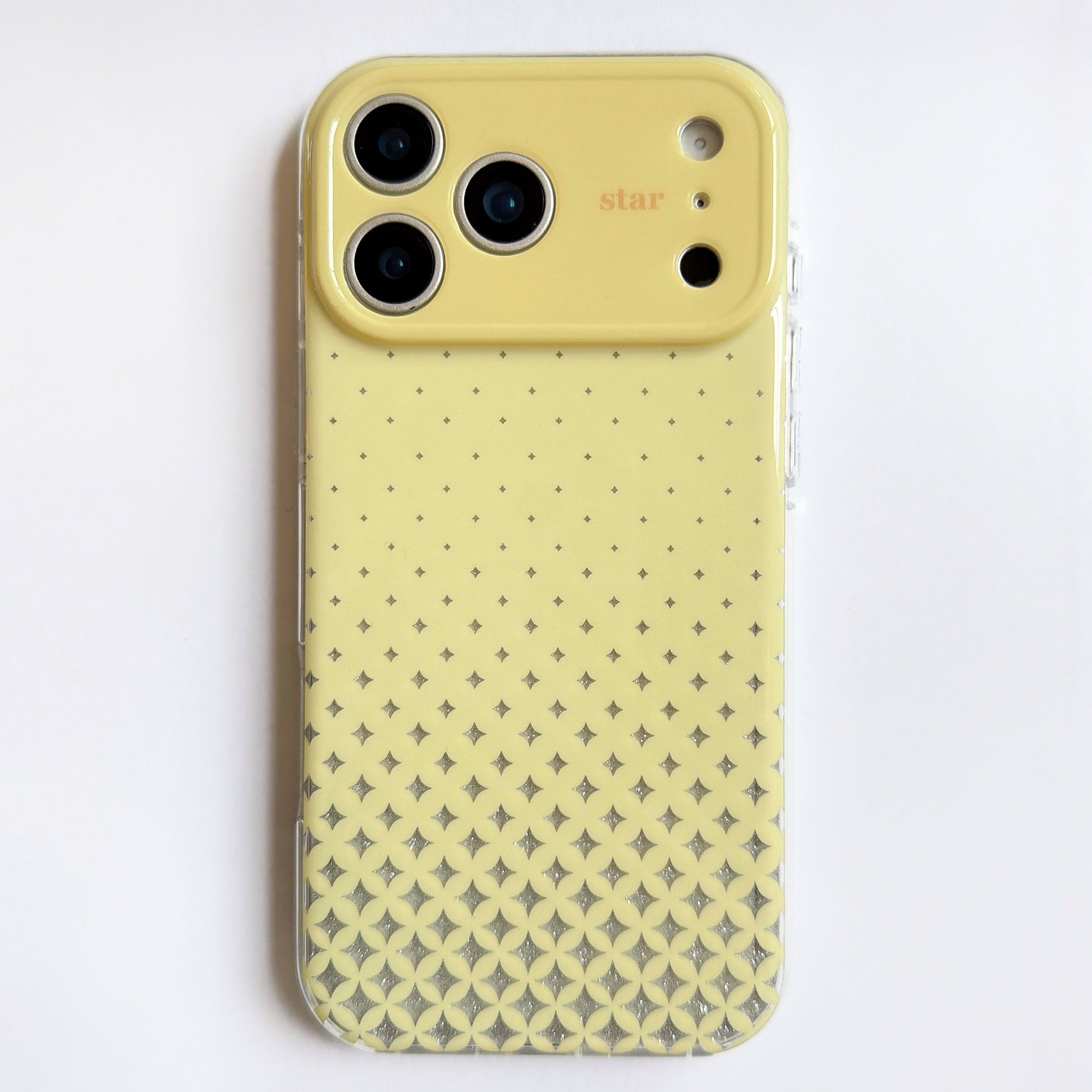 Cream Yellow star iPhone case with glitter detail in natural lighting