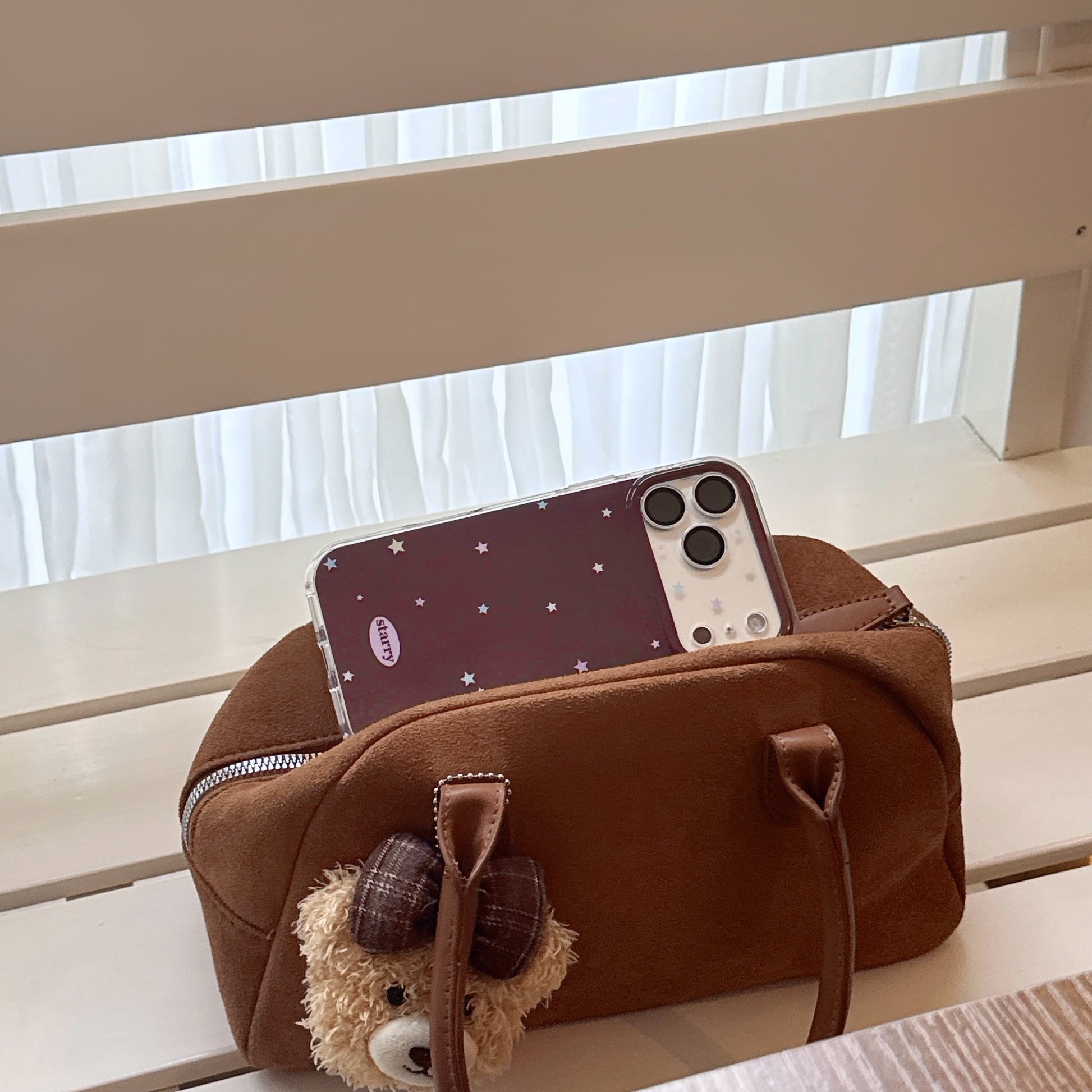 Cute starry iPhone case lifestyle photo – fashion TPU phone case with star pattern and beaded strap – iPhone 17 16 15 series