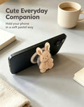 Hand holding a black smartphone with the soft pastel acrylic bunny phone grip showing secure grip hold
