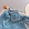 Denim camellia flower Z Flip phone case displayed on matching denim fabric with bow details.