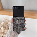 Front-facing view of charcoal gray textured paisley Samsung Z Flip cover featuring silver heart compact mirror pendant.