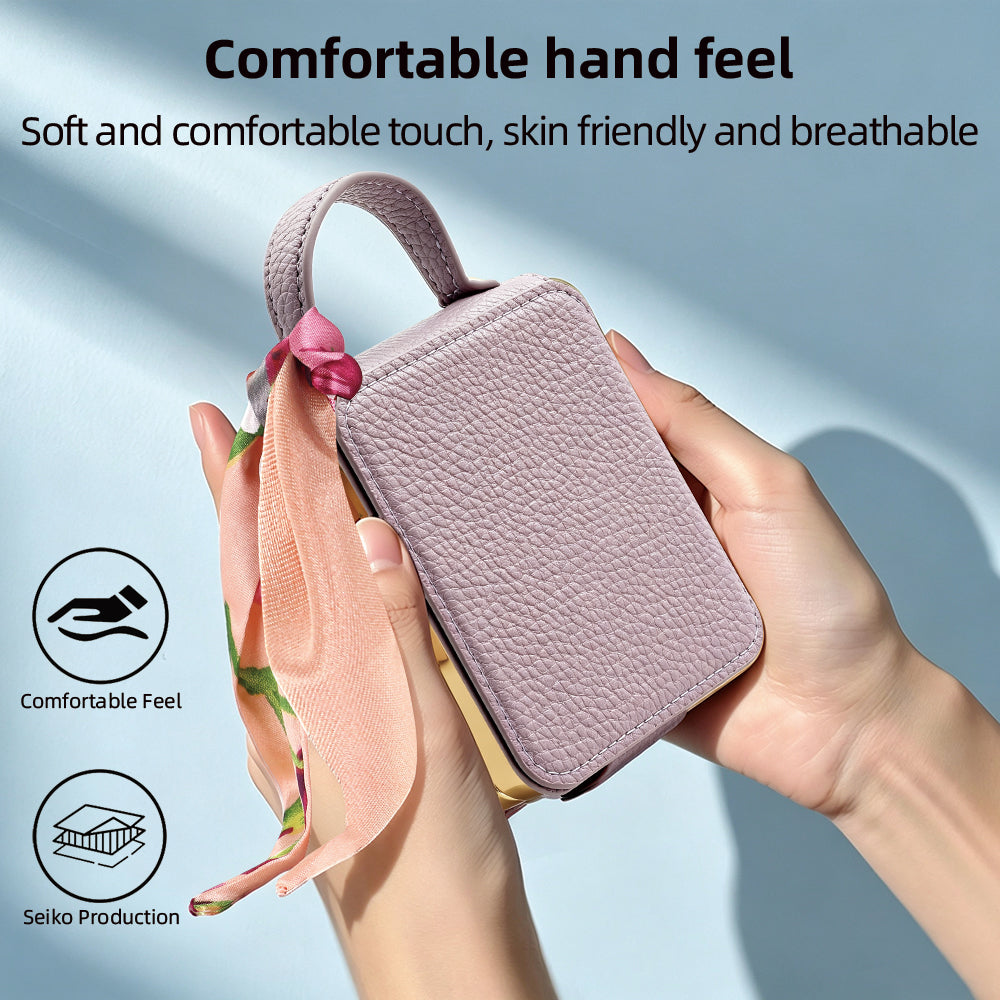 Hand holding a purple skin-friendly textured leather phone case with floral scarf accent