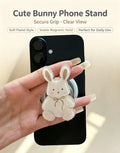 Hand holding a black smartphone with the soft pastel acrylic bunny phone grip showing secure grip hold