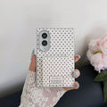 Hand holding a white polka dot Samsung Galaxy Z Fold 8 case showing the closed square flip mirror with sweet quote label.