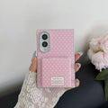 Hand holding the soft pink polka dot Samsung Galaxy Z Fold 8 phone case with closed mirror flap.