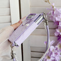 High-angle side view of the pastel lavender marble case for iPhone DUO highlighting the dual-section shell structure, corner bumpers, and pearl lanyard attachment.