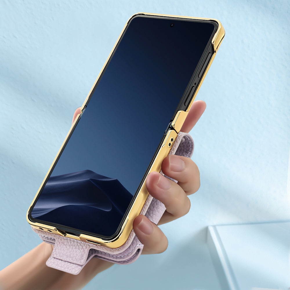 In-hand view of Samsung Galaxy Z Flip in unfolded position with electroplated gold trim and rear strap handle