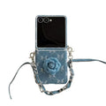Isolated front view of Samsung Galaxy Z Flip denim camellia flower case with attached wrist strap.