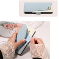 Light-blue pebbled leather flip case. The top panel shows the case from above, closed with a diagonal blue and cream leather pattern and a gold stud button.