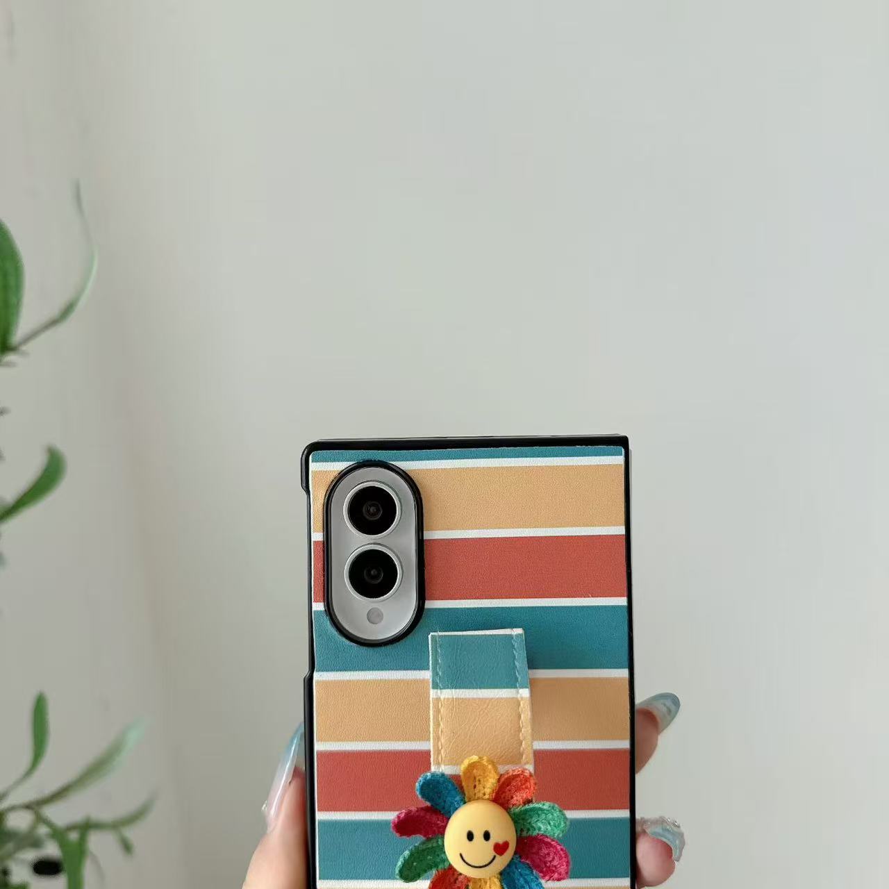 Isolated back view of retro rainbow striped leather case with colorful smiley flower strap band for Samsung Galaxy Z Fold