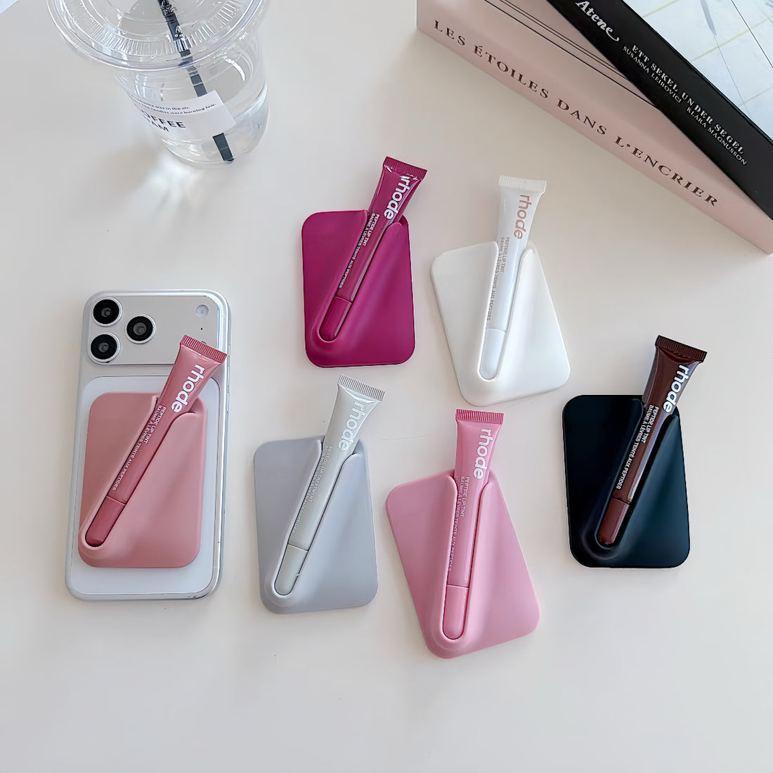 MagSafe lip gloss holder phone wallet flat lay – 6 silicone lipstick sleeve colourways with Rhode lip gloss tubes, by wobomatic

