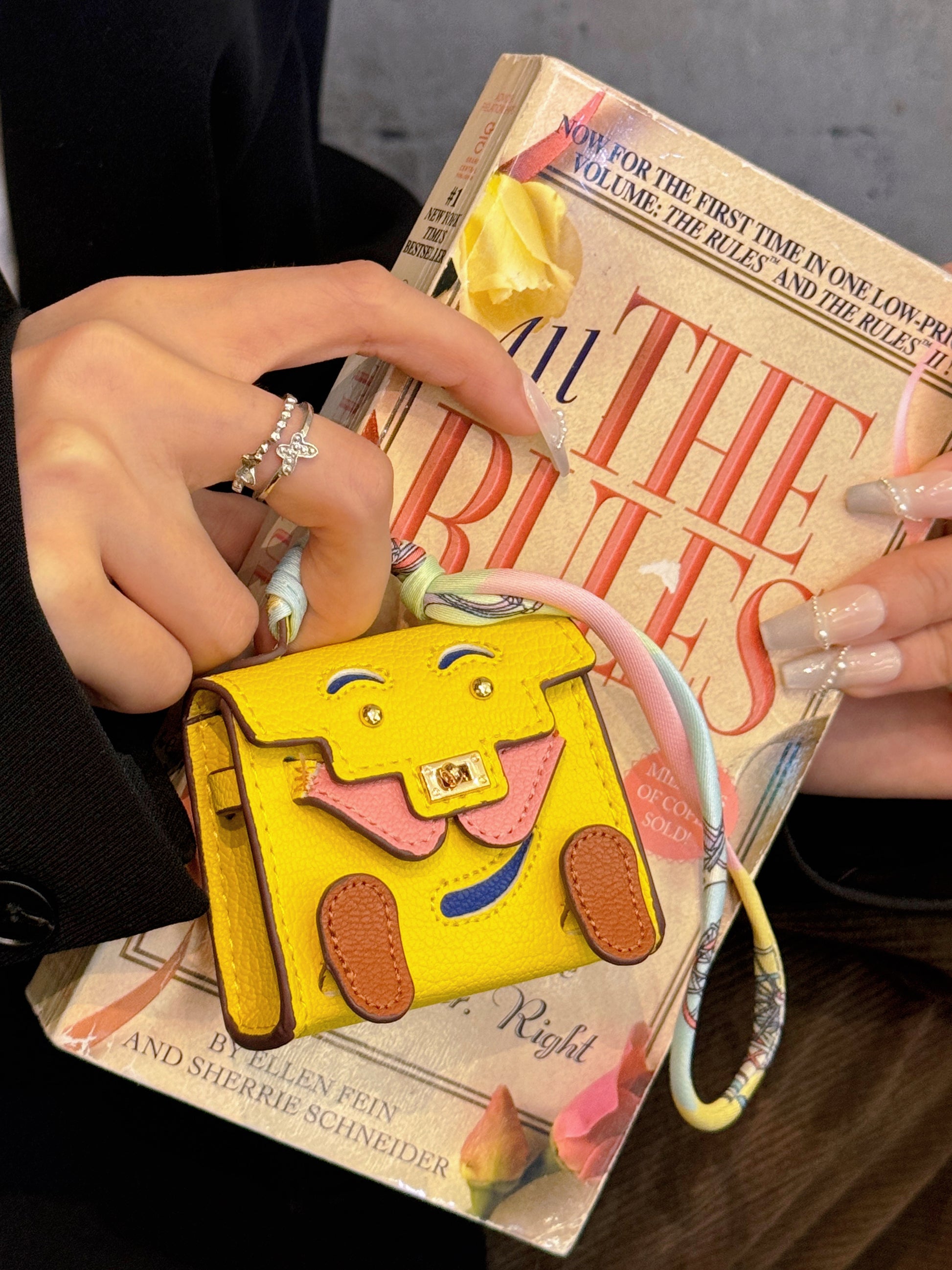 Size comparison of mini leather handbag pendant for AirPods, compact and lightweight design