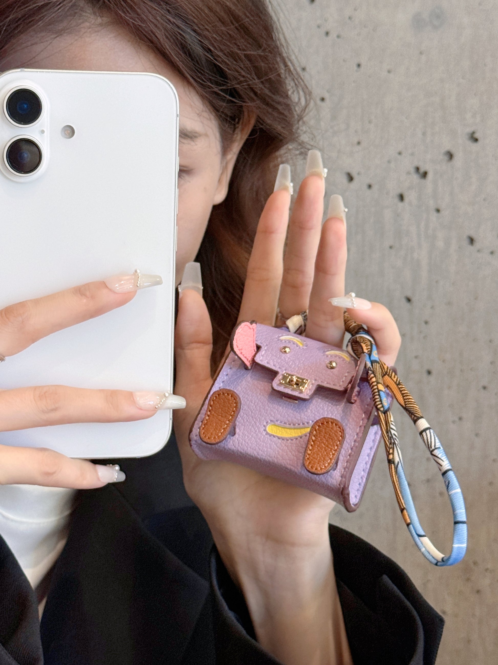 Size comparison of mini leather handbag pendant for AirPods, compact and lightweight design