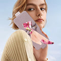 Model holding a purple luxury leather handbag case for Samsung Galaxy Z Flip with floral silk scarf