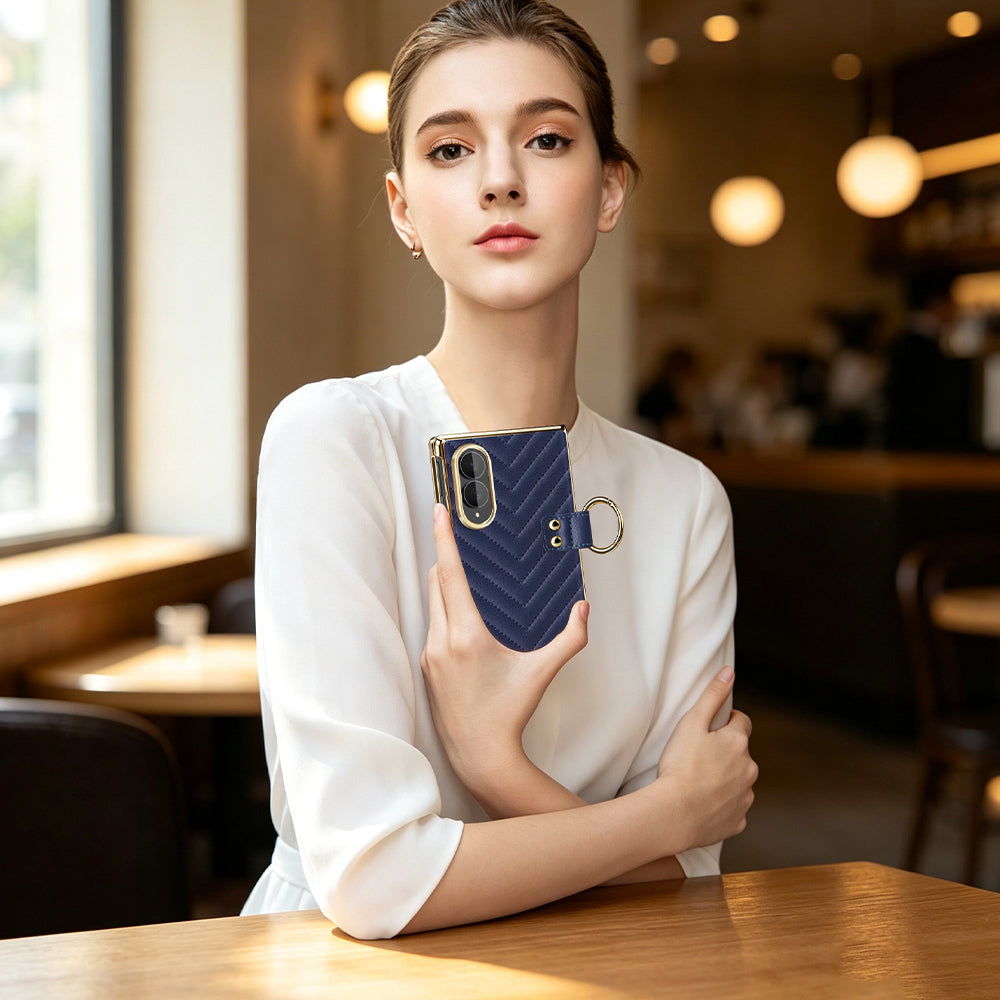 Model sitting in cafe holding navy blue luxury chevron leather Samsung Galaxy Z Fold 8 case with gold ring holder