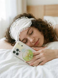Person holding smartphone with green tropical coconut drink liquid shaker grip featuring 360 degree rotation feature