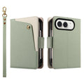 Sage green dual-tone leather wallet case for iPhone DUO displaying the front cover with a brass snap button card flap, back camera cutout, and wristlet strap.
