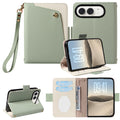 Sage green dual-tone leather wallet case for iPhone DUO showcasing wristlet strap attachment, folded back kickstand mode, camera cutout, and open card slots.