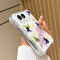 Angled view of the clear iPhone DUO Garden Floral case held in a hand, showing the camera bezel and clear bumper frame.
