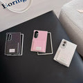 Three polka dot Samsung Galaxy Z Fold 8 phone cases in black, pink, and white with flip mirrors laid flat on a surface.