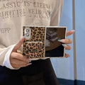 Unfolded Samsung Galaxy Z Fold held open showing main inner display and leopard print vanity mirror case back