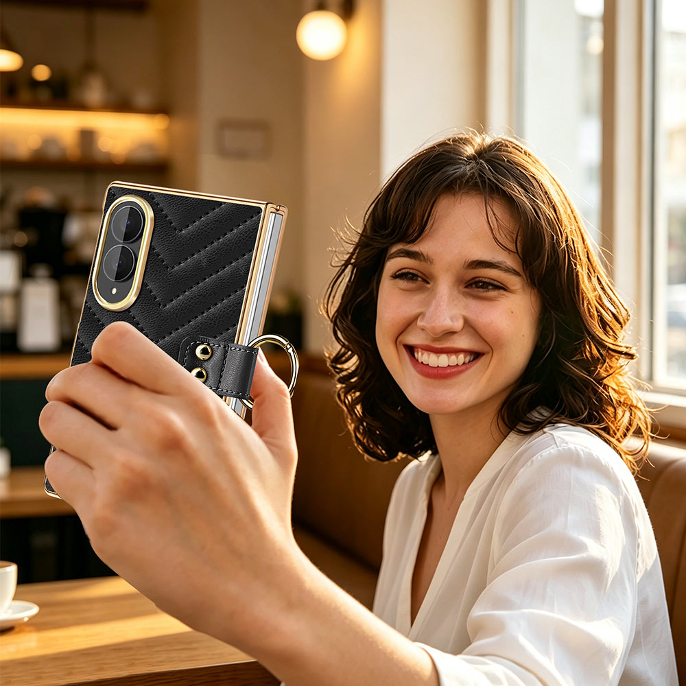 Woman holding black luxury quilted leather Samsung Galaxy Z Fold 8 case with gold ring holder taking a selfie