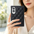 Woman holding a black diamond-stitched leather case on a Samsung Galaxy Z Fold 8