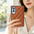 Woman holding a saddle brown quilted diamond leather case on a folded Samsung Galaxy Z Fold 8.