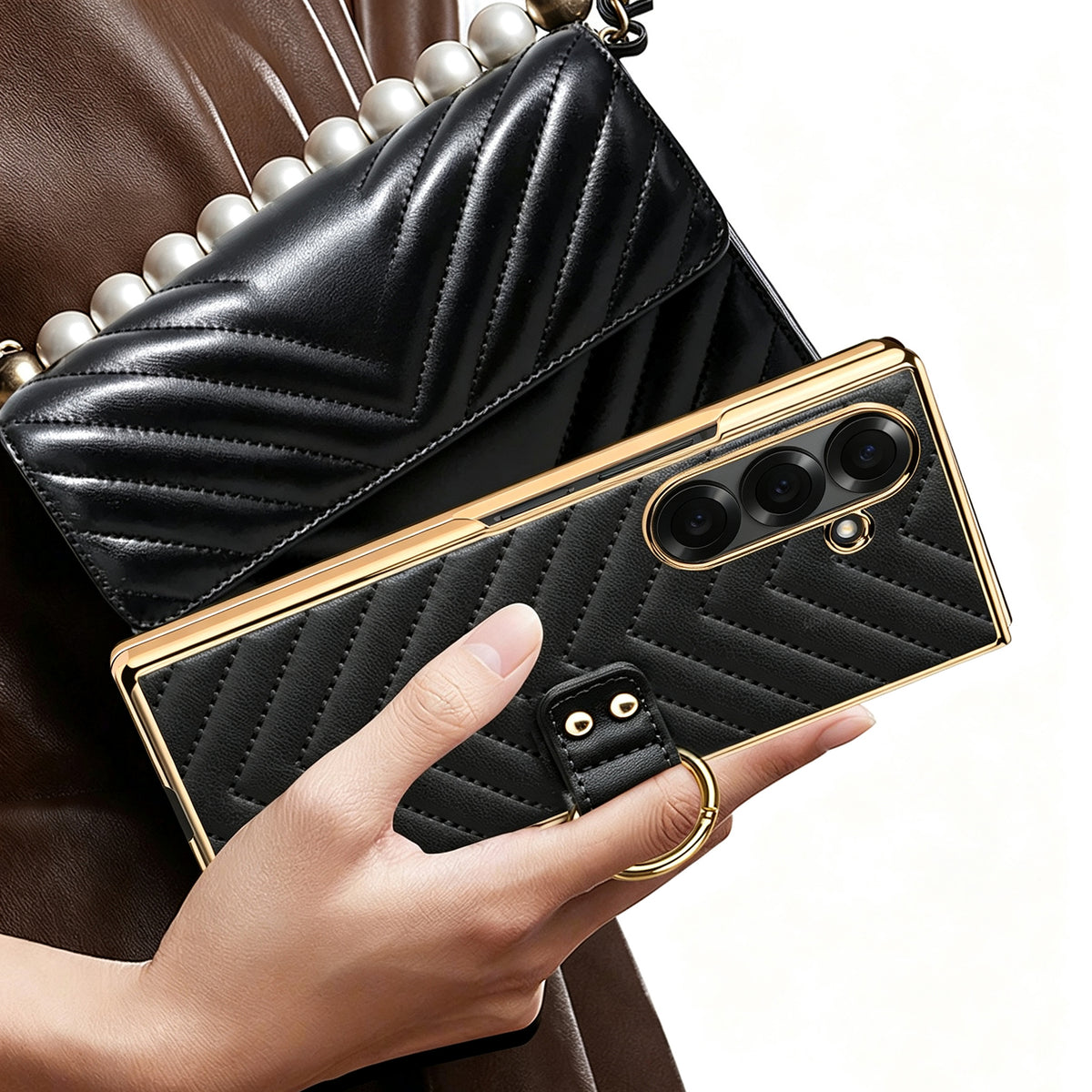 Woman holding black luxury chevron leather ring case for Samsung Galaxy Z Fold next to matching handbag