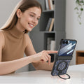 Woman using a Samsung Galaxy Z Flip phone set up on a desk using the built-in ring kickstand of a blue glitter case.