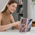 Woman using a Samsung Galaxy Z Fold phone supported in landscape mode by the 360-degree rotating ring kickstand on a rose gold glitter case.