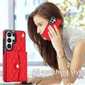 Woman using phone with crimson red quilted leather Samsung Galaxy phone case featuring snap wallet and gold hardware