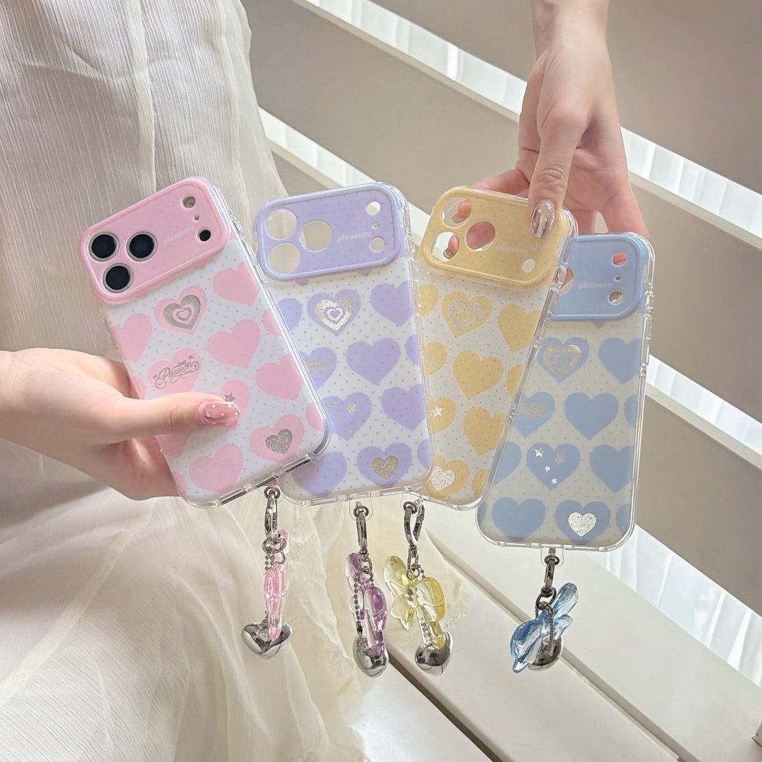 iPhone heart pattern phone case with bow charm showing double-layer IMD gradient design with colorful hearts and silver glitter accents